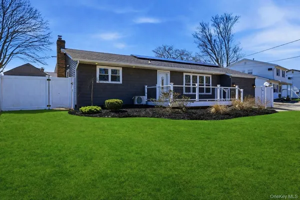 a view of a house with a yard and potted plants