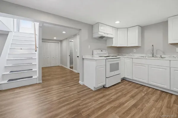 a view of kitchen with furniture and wooden floor