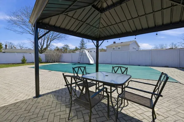 a view of a backyard with potted plants and large tree