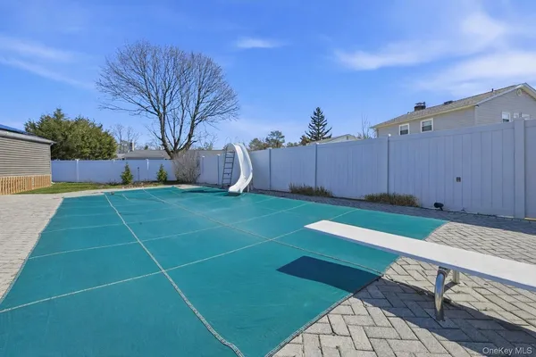 a view of a house with pool and a yard