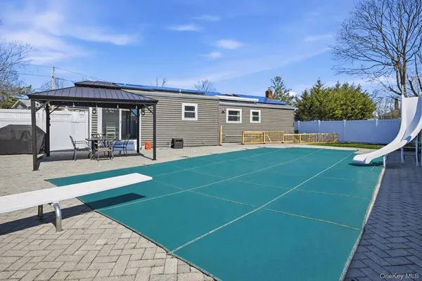 a view of a house with a yard and sitting area
