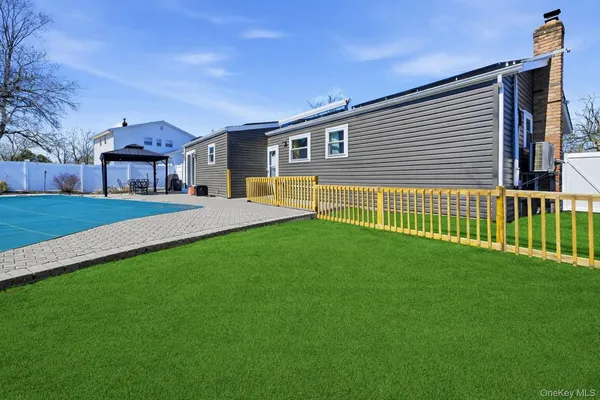 a view of a house with a backyard and a garage