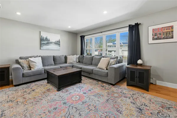a living room with furniture rug and window