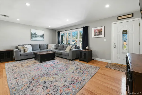 a living room with furniture and a rug