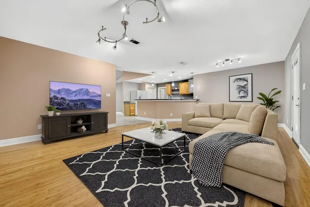 a living room with furniture and a flat screen tv