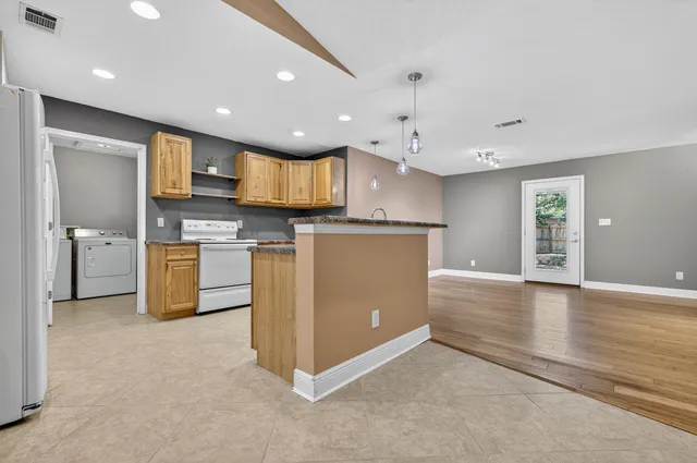 a view of kitchen with cabinets and wooden floor