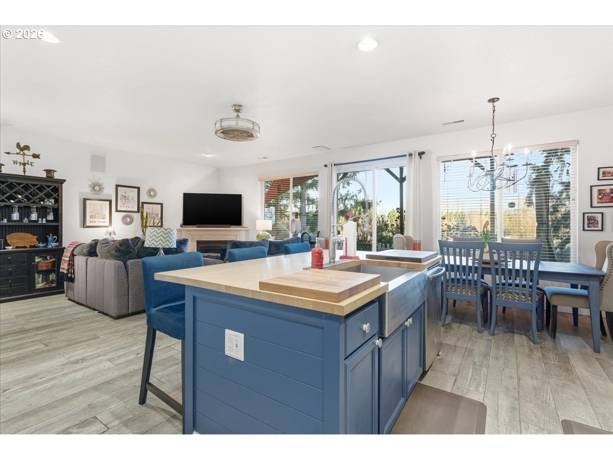21601 Northeast Willow Glen Road Fairview, OR 97024 - Photo 15 of 48 a dining hall with stainless steel appliances granite countertop a sink dishwasher and a flat screen tv