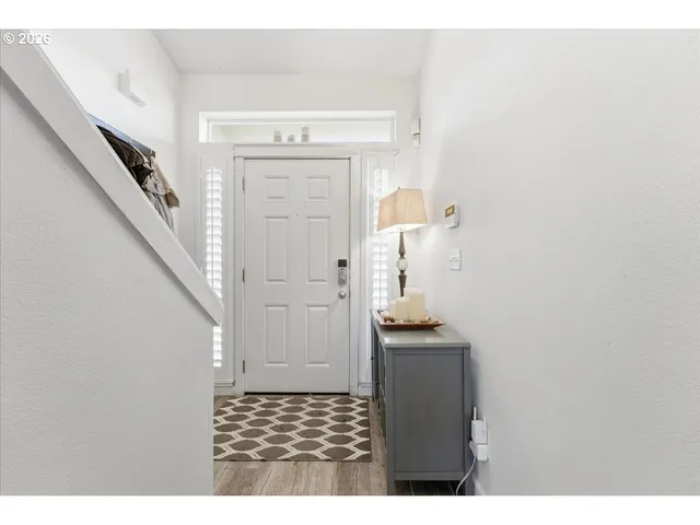 a bedroom with a bed a dresser and a large window
