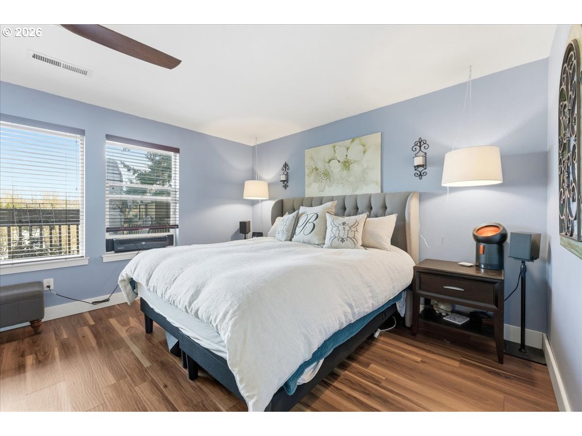 21601 Northeast Willow Glen Road Fairview, OR 97024 - Photo 20 of 48 a bedroom with a bed a dresser and a large window