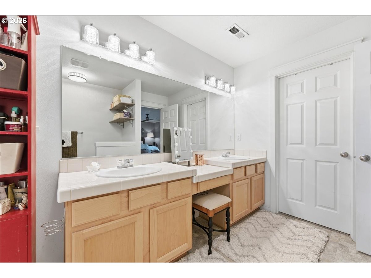 21601 Northeast Willow Glen Road Fairview, OR 97024 - Photo 24 of 48 a spacious bathroom with a sink a mirror and a bathtub
