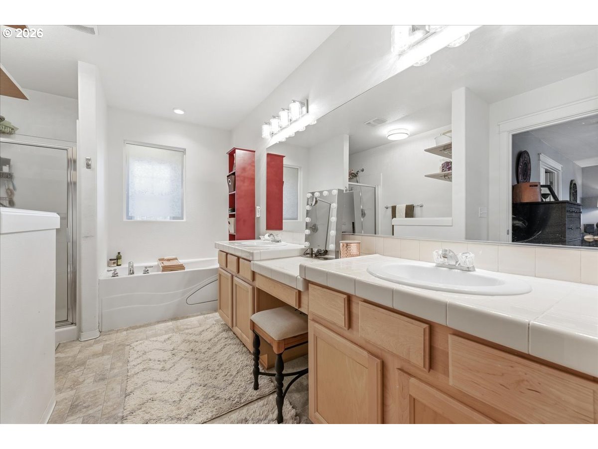21601 Northeast Willow Glen Road Fairview, OR 97024 - Photo 25 of 48 a bathroom with a sink double vanity granite tub shower and a mirror