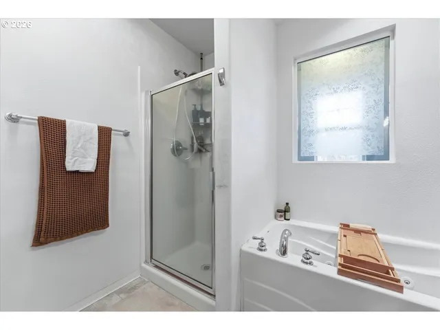 a view of walk in closet with clothes