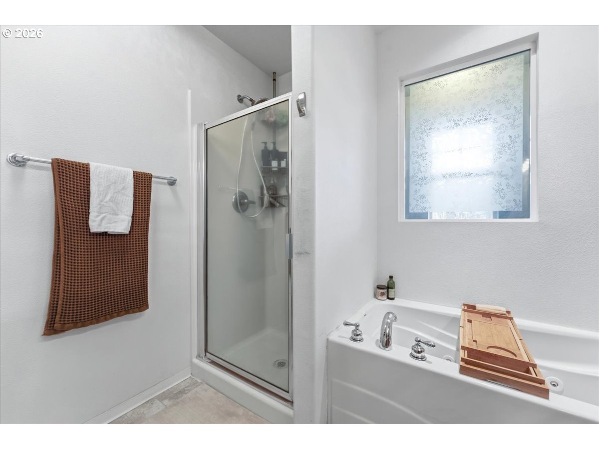 21601 Northeast Willow Glen Road Fairview, OR 97024 - Photo 26 of 48 a bathroom with a bathtub and a shower