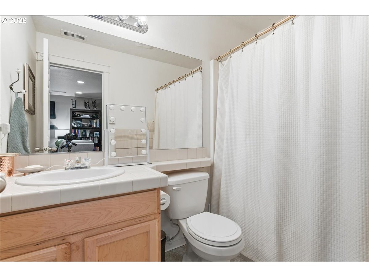 21601 Northeast Willow Glen Road Fairview, OR 97024 - Photo 31 of 48 a bathroom with a sink toilet and a mirror
