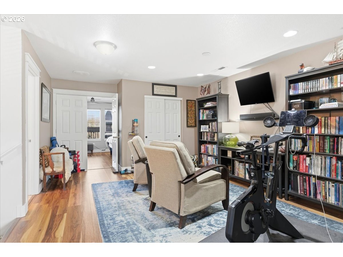 21601 Northeast Willow Glen Road Fairview, OR 97024 - Photo 36 of 48 a living room with furniture and a flat screen tv