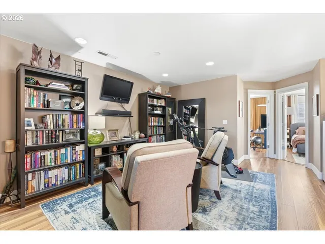 a view of walk in closet with clothes and washer