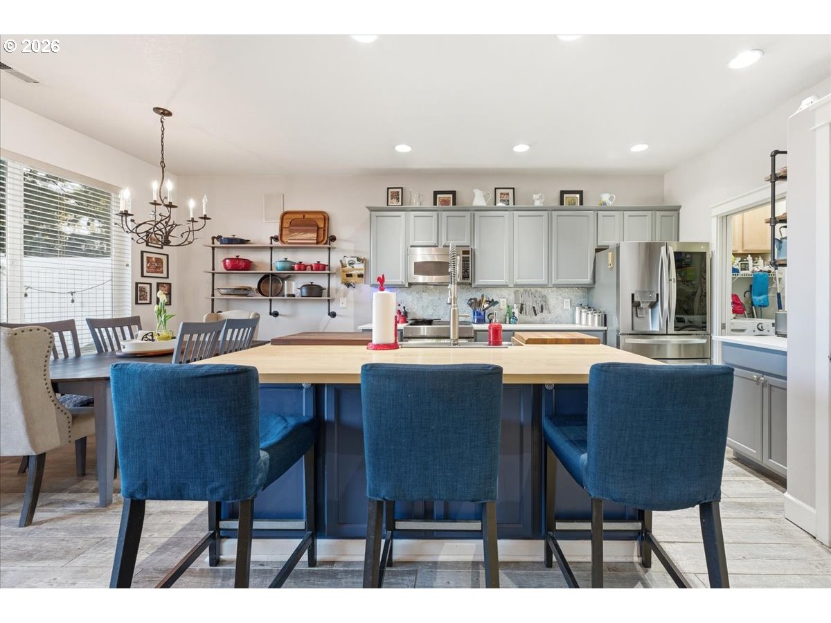 21601 Northeast Willow Glen Road Fairview, OR 97024 - Photo 4 of 48 a kitchen with a dining table chairs and refrigerator