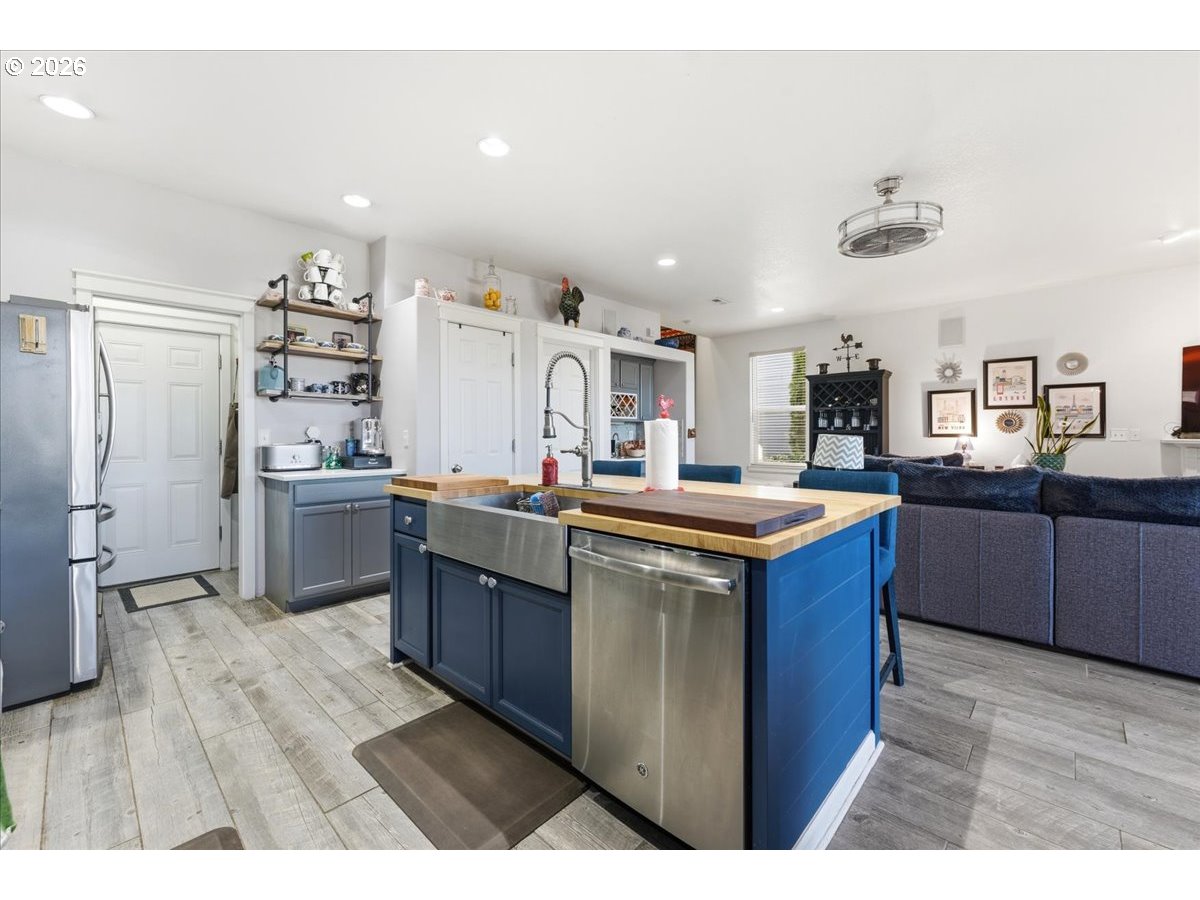 21601 Northeast Willow Glen Road Fairview, OR 97024 - Photo 7 of 48 a kitchen with stainless steel appliances granite countertop a sink and wooden cabinets