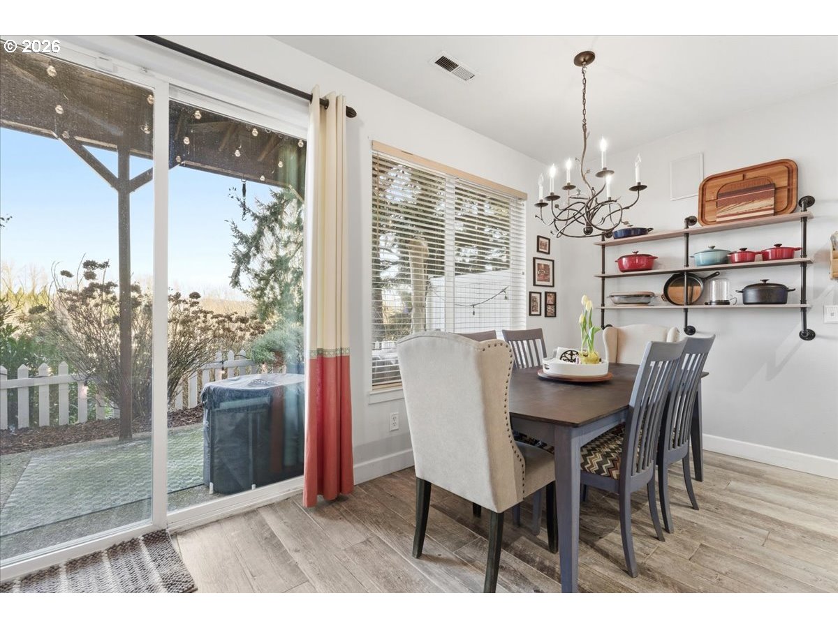 21601 Northeast Willow Glen Road Fairview, OR 97024 - Photo 8 of 48 a view of a dining room with furniture wooden floor and chandelier