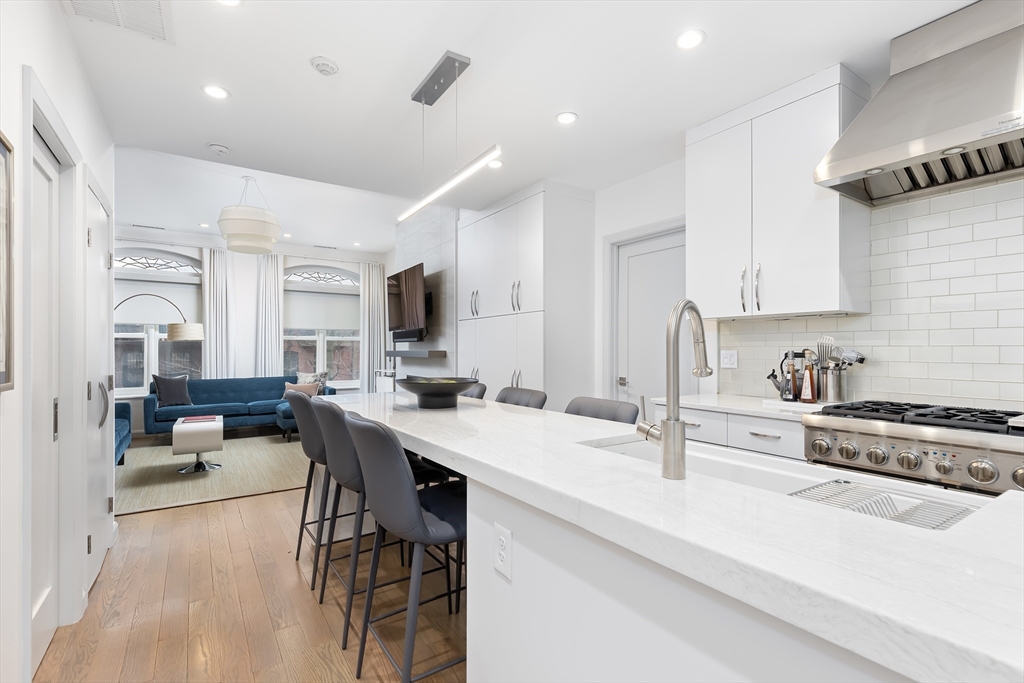 76 West Rutland Square, Unit 104 Boston, MA 02118 - Photo 11 of 23 a large white kitchen with sink and cabinets