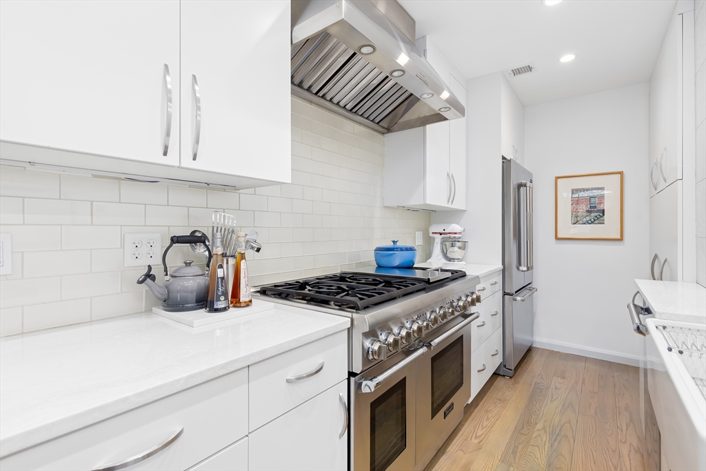76 West Rutland Square, Unit 104 Boston, MA 02118 - Photo 12 of 23 a kitchen with stainless steel appliances granite countertop a sink stove and cabinets