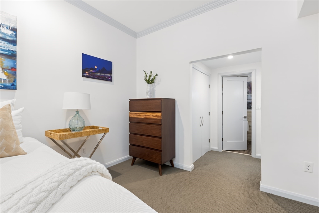 76 West Rutland Square, Unit 104 Boston, MA 02118 - Photo 15 of 23 a bedroom with a bed and cabinets