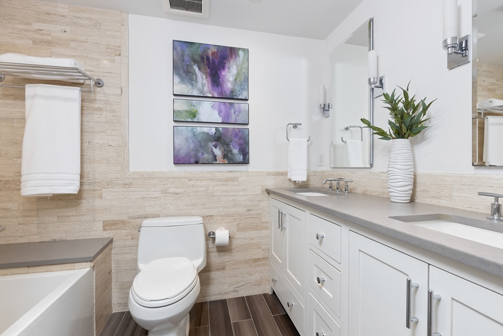 76 West Rutland Square, Unit 104 Boston, MA 02118 - Photo 16 of 23 a bath room with a toilet a sink and a mirror