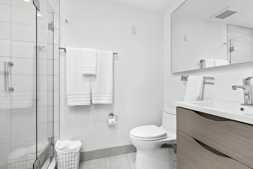 76 West Rutland Square, Unit 104 Boston, MA 02118 - Photo 18 of 23 a bathroom with a toilet a sink and mirror