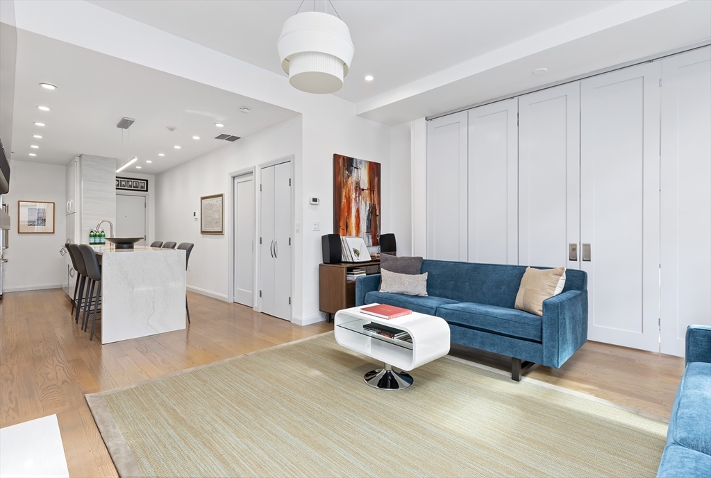 76 West Rutland Square, Unit 104 Boston, MA 02118 - Photo 2 of 23 a living room with furniture and wooden floor