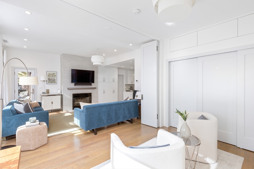 76 West Rutland Square, Unit 104 Boston, MA 02118 - Photo 4 of 23 a living room with furniture and a fireplace with wooden floor