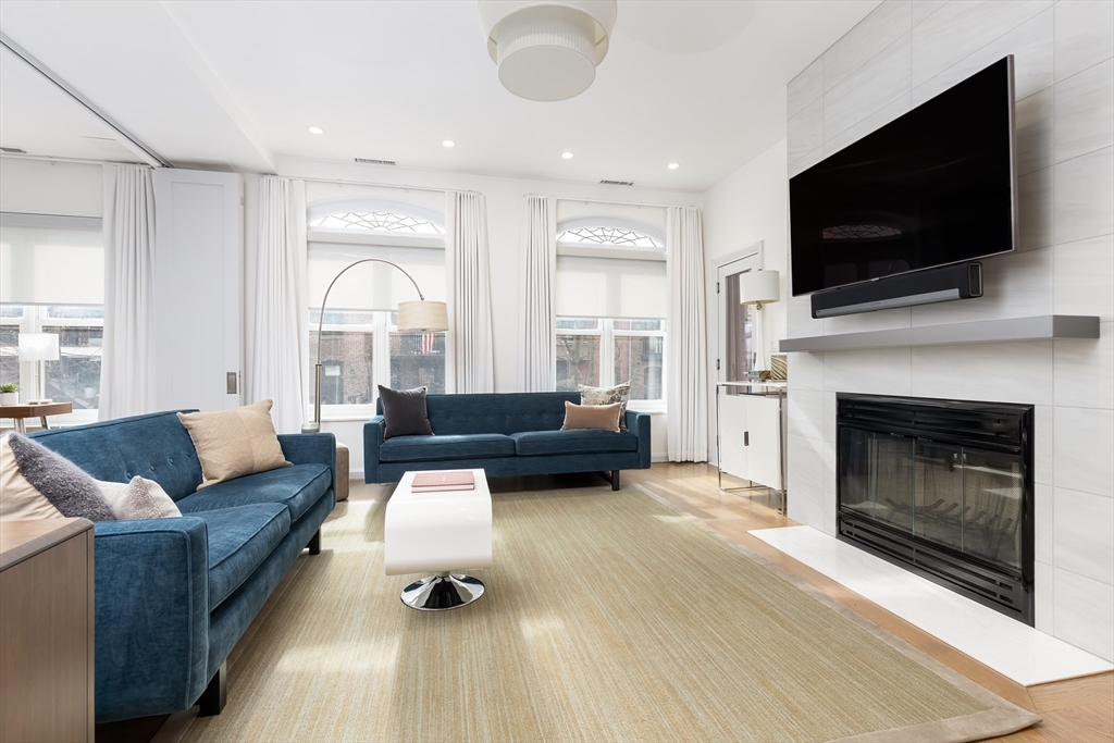 76 West Rutland Square, Unit 104 Boston, MA 02118 - Photo 5 of 23 a living room with furniture flat screen tv and a fireplace