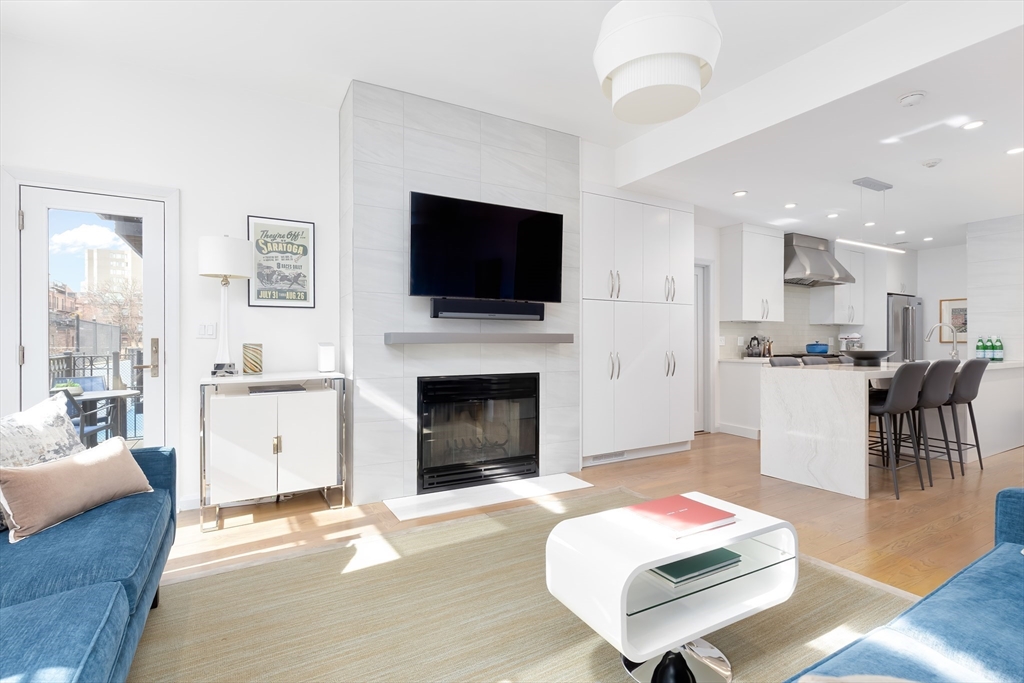 76 West Rutland Square, Unit 104 Boston, MA 02118 - Photo 6 of 23 a living room with furniture fireplace and flat screen tv