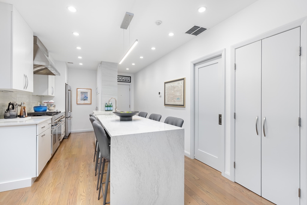 76 West Rutland Square, Unit 104 Boston, MA 02118 - Photo 10 of 23 a kitchen with a sink a counter top space and appliances