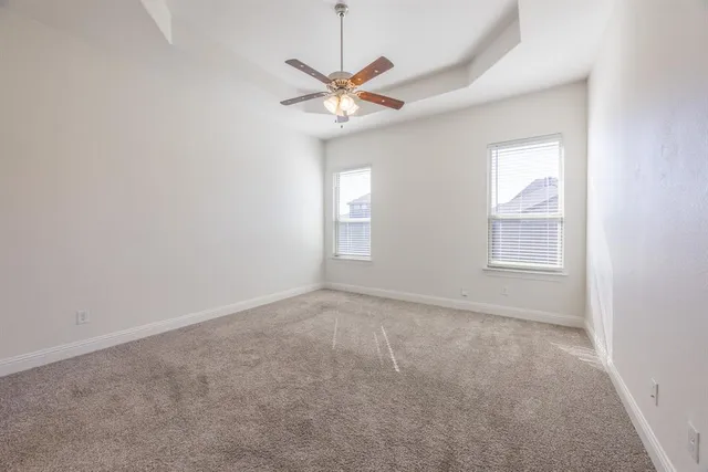 a view of a livingroom with a ceiling fan and window