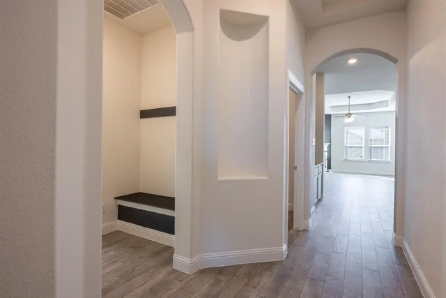 a view of a hallway with wooden floor
