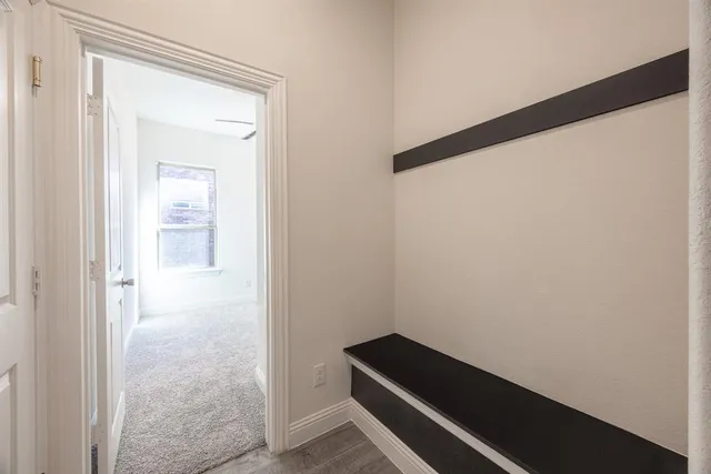 a view of closet with wooden floor