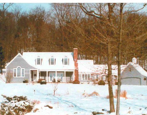 2 Upland Pastures Road Sherman, CT 06784 - Photo 1 of 1 a front view of a house with a yard covered with snow