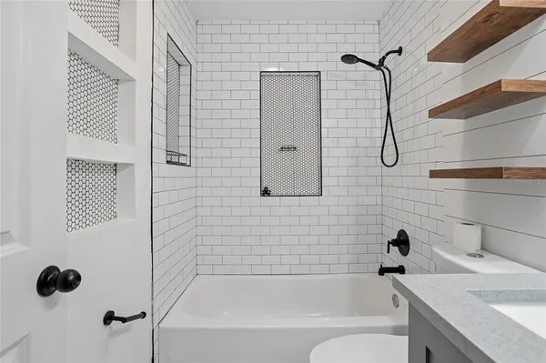 a bathroom with a tub and shower