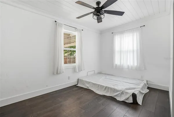 a spacious bedroom with a bed and a window
