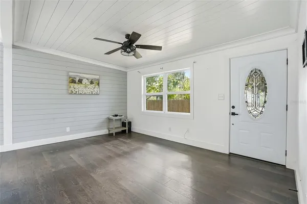 wooden floor in an empty room with a window