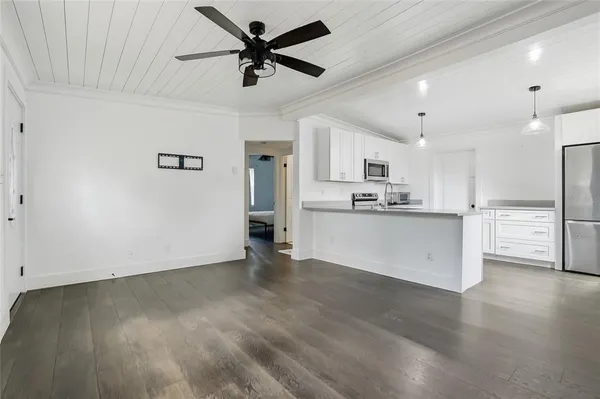 a view of a kitchen with a sink and wooden floor