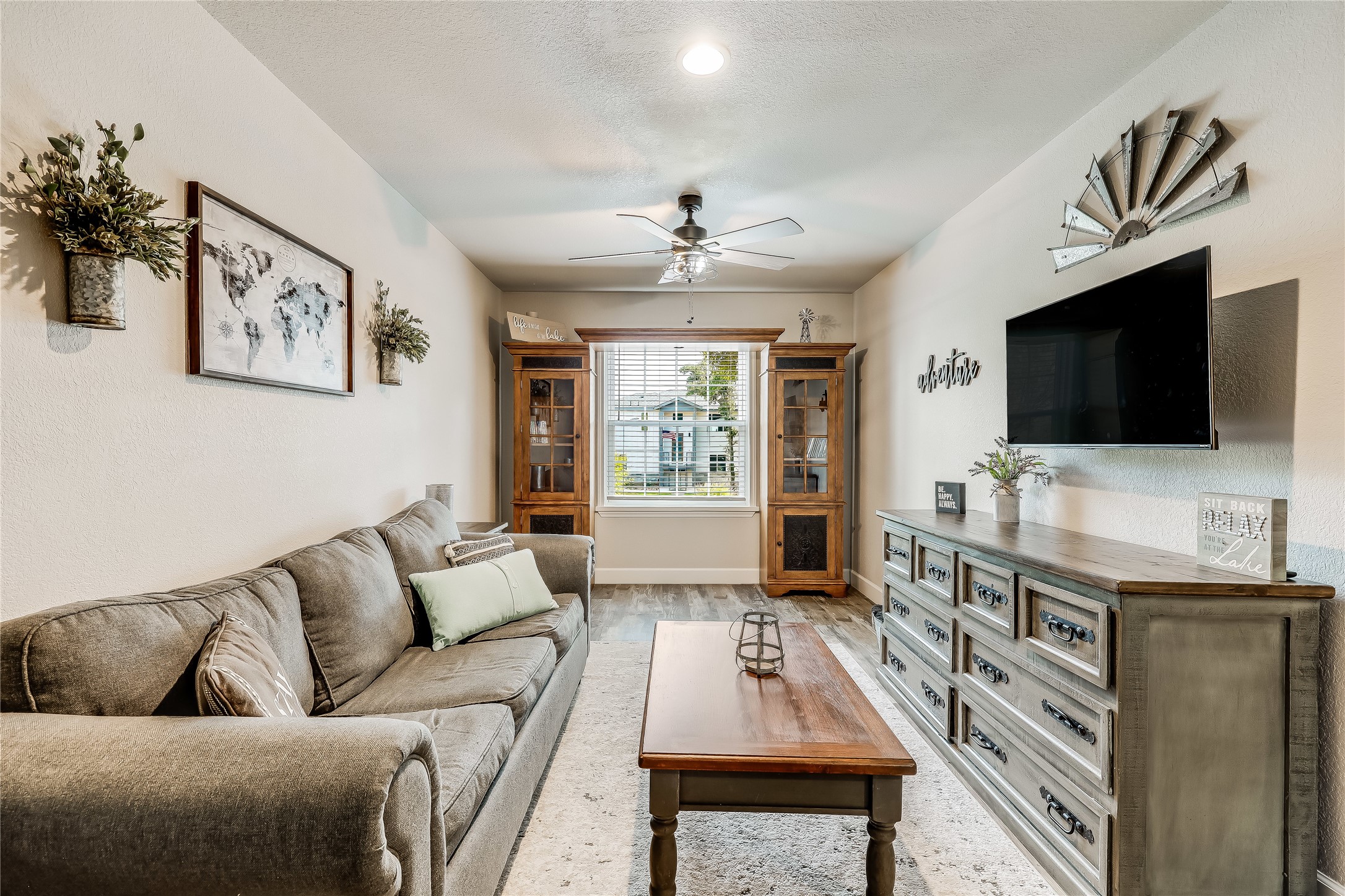 426 Summit Ridge Drive North Point Venture, TX 78645 - Photo 21 of 28 Living room with a textured ceiling, wood-type flooring, and ceiling fan