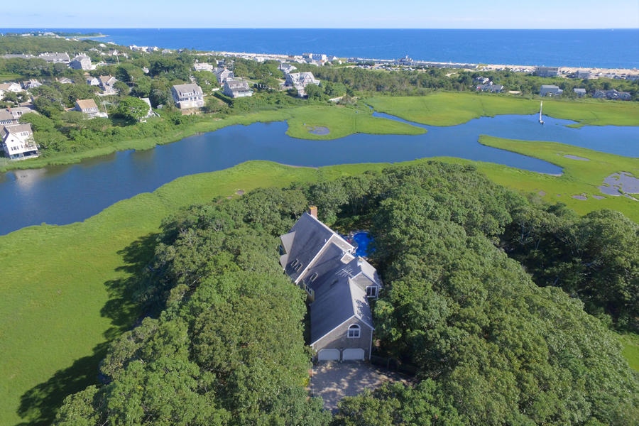 494 Elliott Road Centerville, MA 02632 - Photo 1 of 31 an aerial view of a house with a garden and lake view