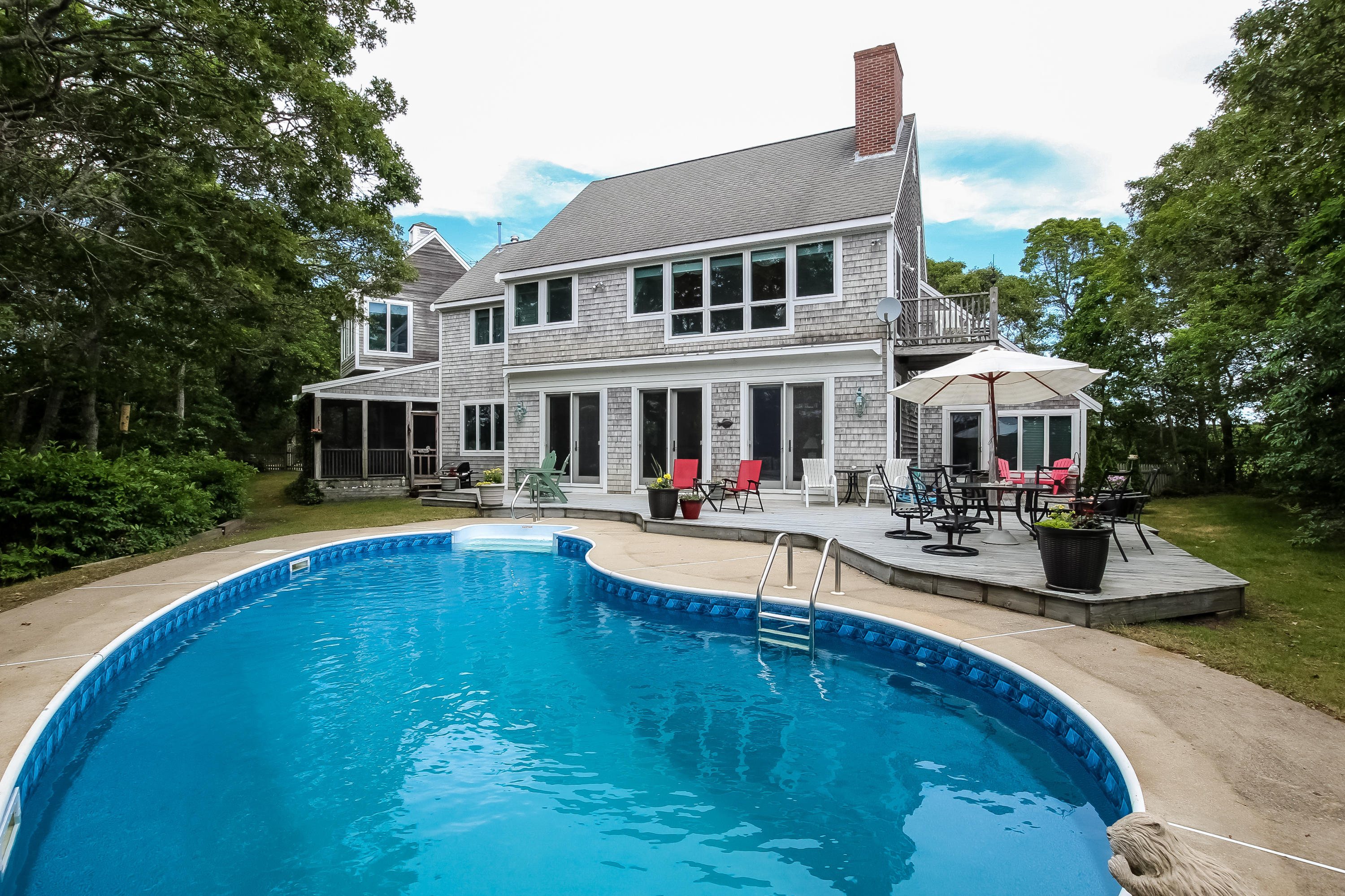494 Elliott Road Centerville, MA 02632 - Photo 2 of 31 a swimming pool view with a seating space and a garden view