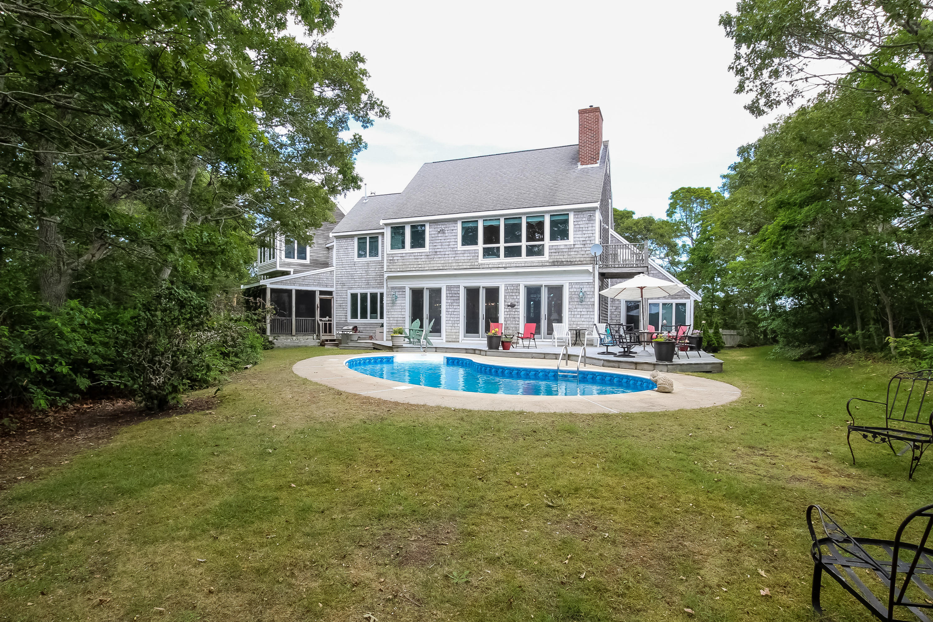 494 Elliott Road Centerville, MA 02632 - Photo 28 of 31 a front view of a house with swimming pool having outdoor seating