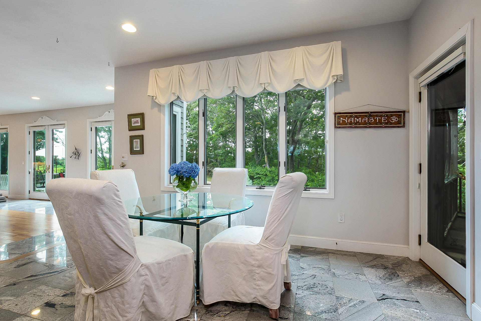494 Elliott Road Centerville, MA 02632 - Photo 7 of 31 a view of a dining room with furniture large windows and wooden floor