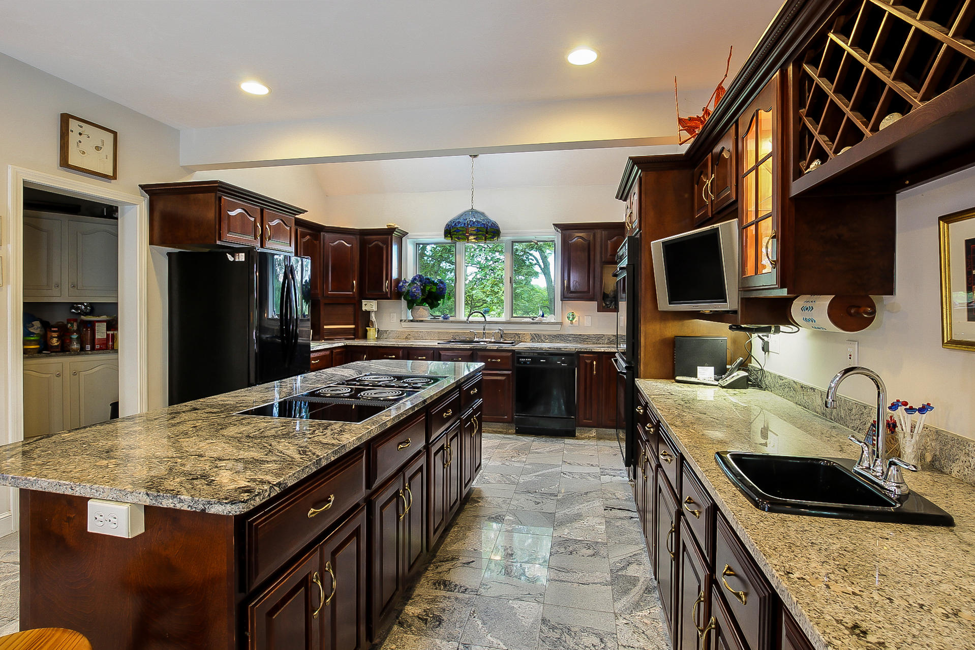494 Elliott Road Centerville, MA 02632 - Photo 9 of 31 a kitchen with kitchen island granite countertop a sink stove and refrigerator