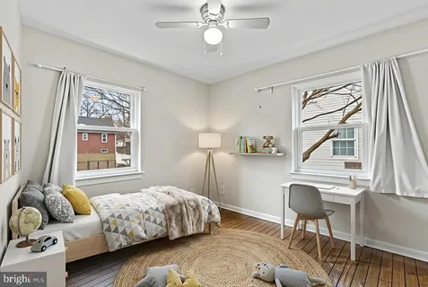 a bedroom with a bed couch and a window