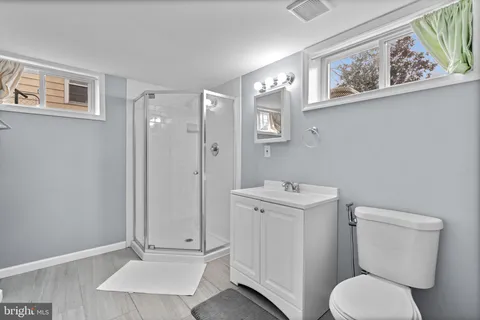 a backyard of apartments with large trees