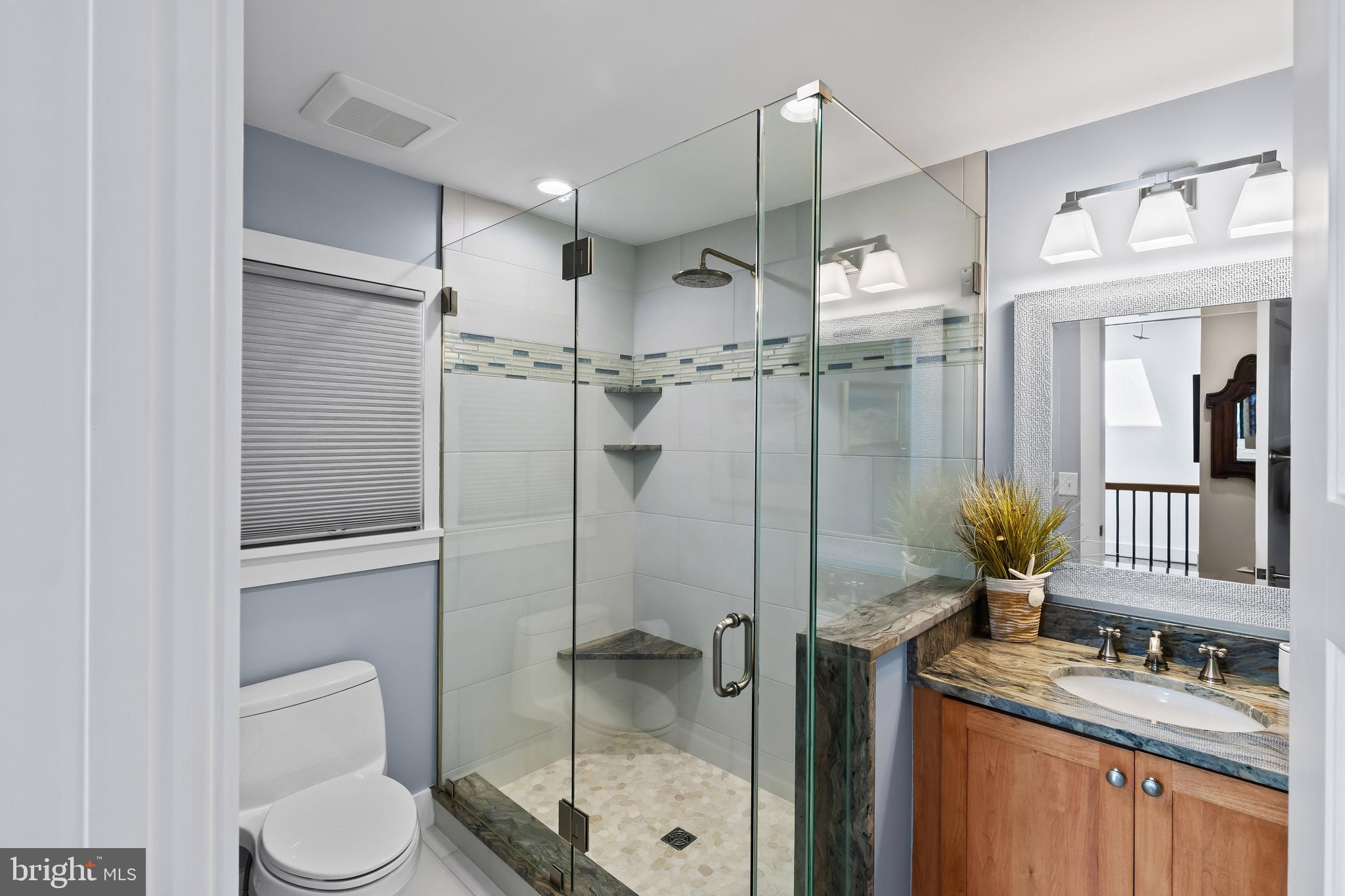 1428 Ravine Way Arnold, MD 21012 - Photo 18 of 43 a bathroom with a granite countertop sink toilet and shower